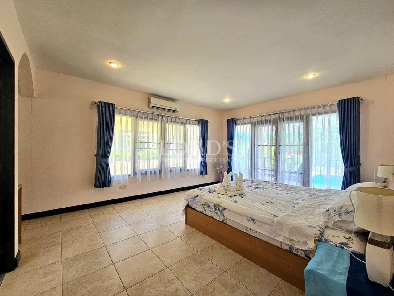 Spacious bedroom with large windows.