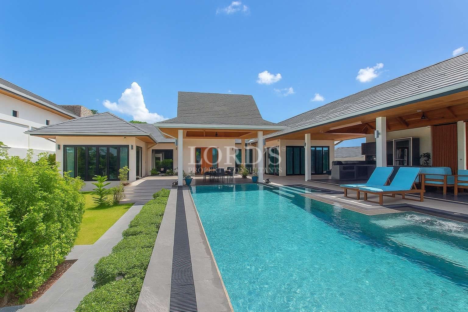 Luxury modern villa with private swimming pool and covered outdoor lounge.