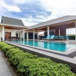 Luxury modern villa with private swimming pool, covered terrace, and outdoor lounge seating.