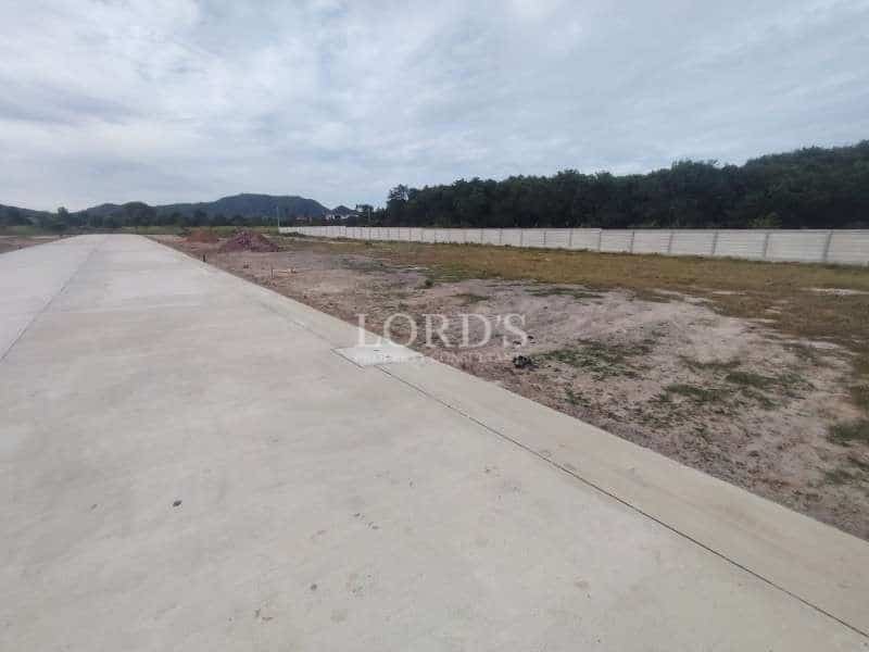 Empty land with concrete pathway.