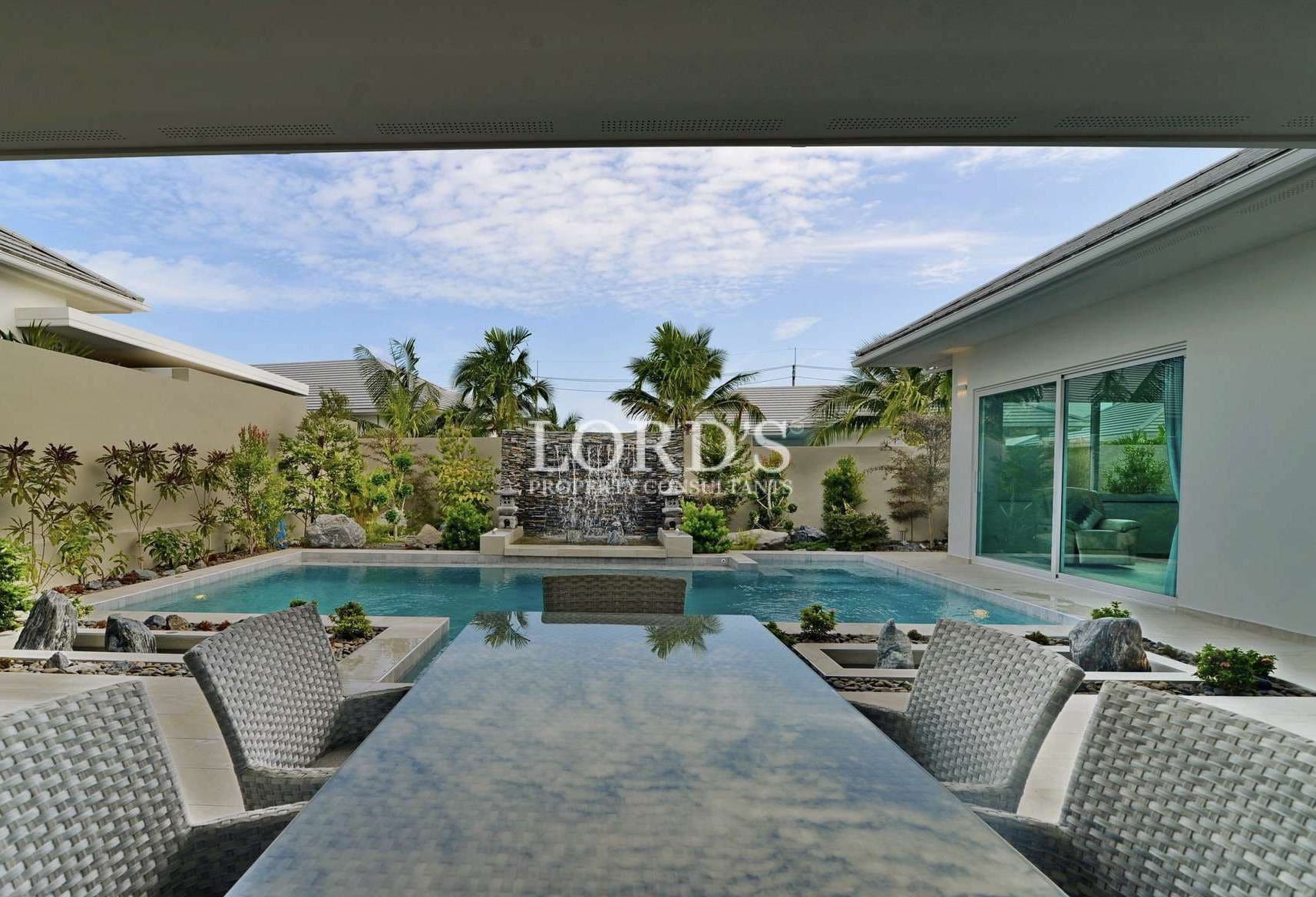 Luxurious poolside view with greenery.
