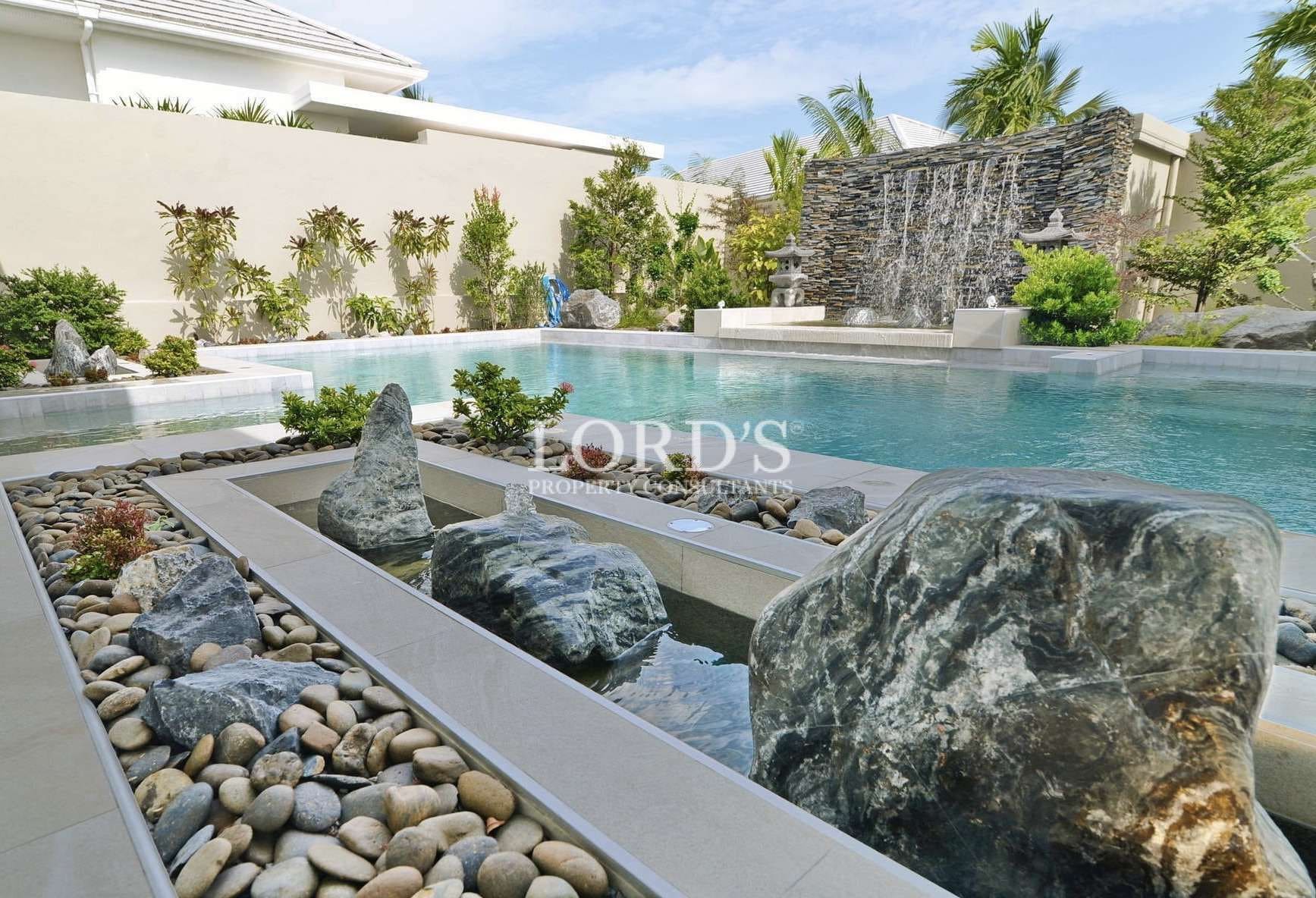 Serene pool with rocks and waterfall