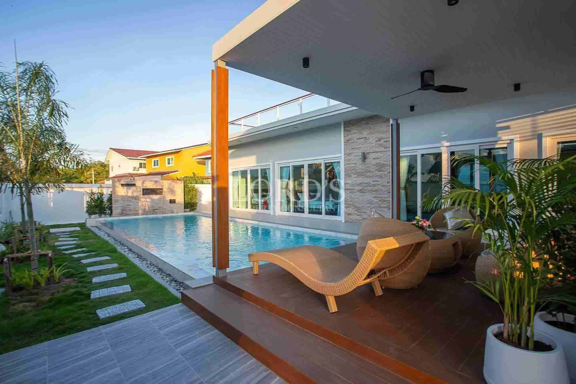 Modern poolside lounge area with greenery