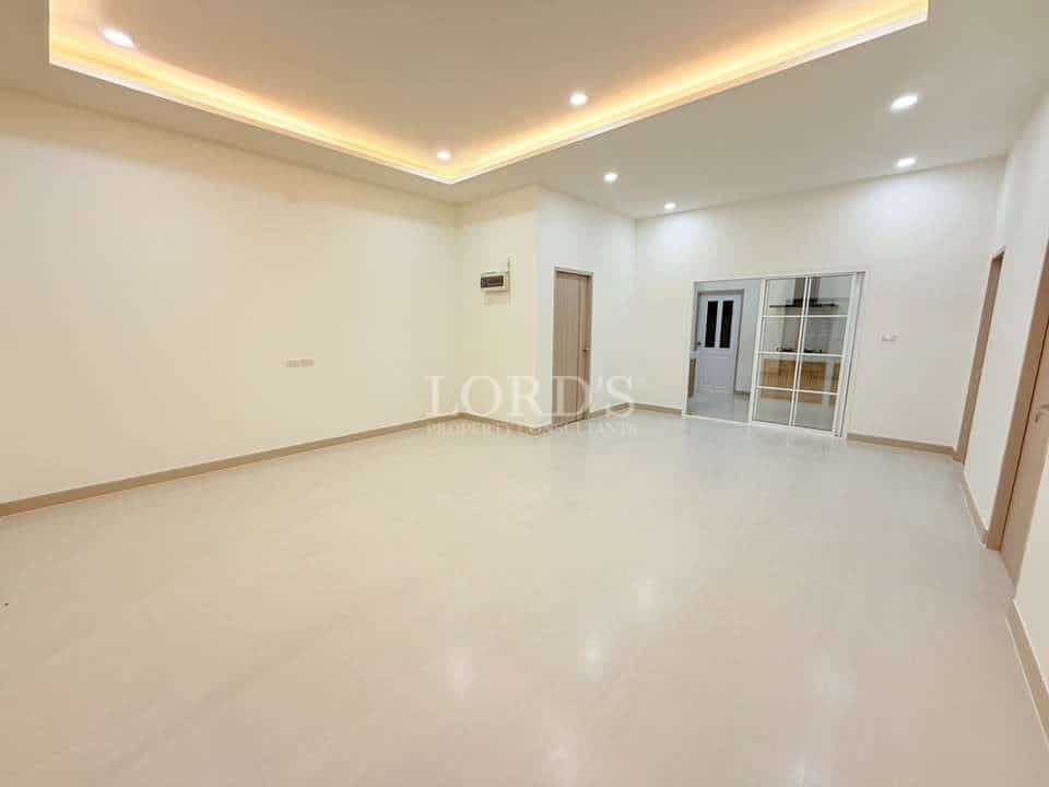 Spacious, empty room with lighting.