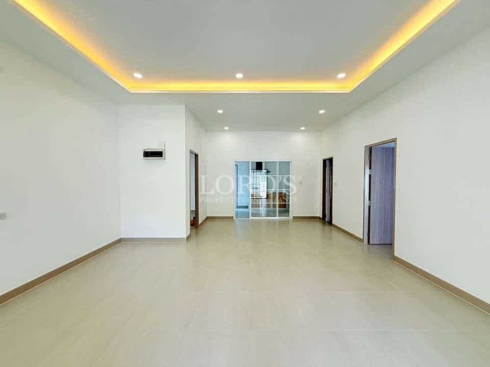 Spacious, empty room with modern design.