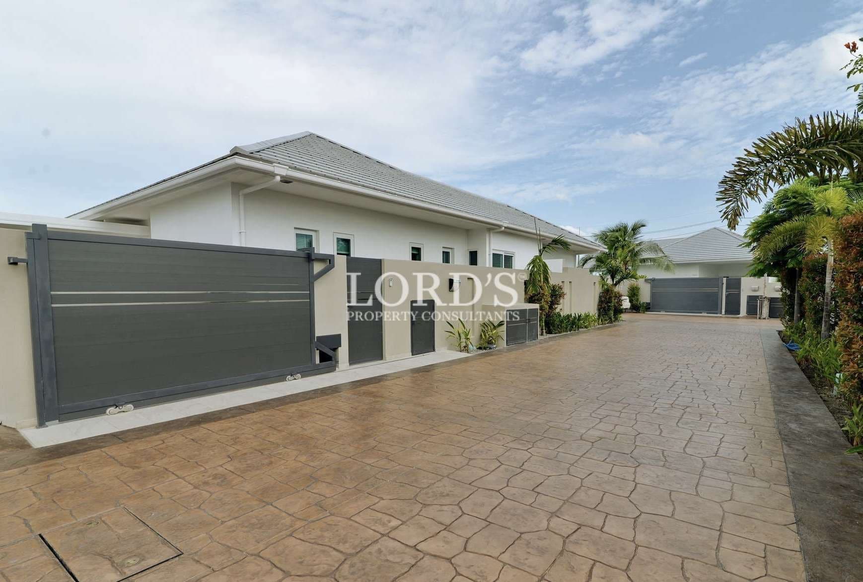 Modern house with landscaped driveway.