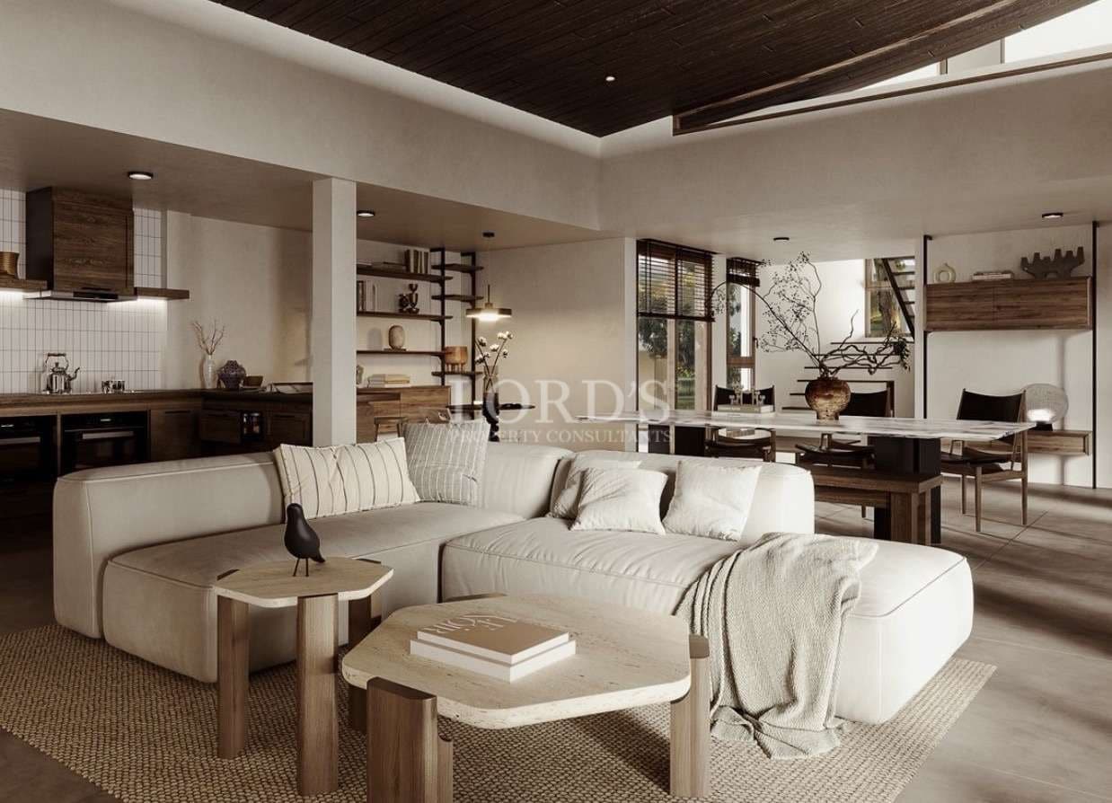 Modern open-plan living room with neutral tones, wood accents, and minimalist furniture.