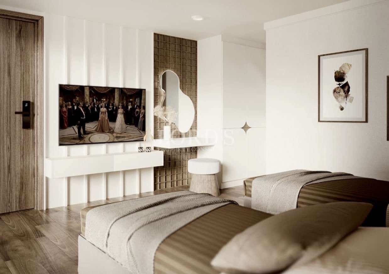 Modern bedroom interior with wall-mounted TV, minimalist decor, and neutral color palette.
