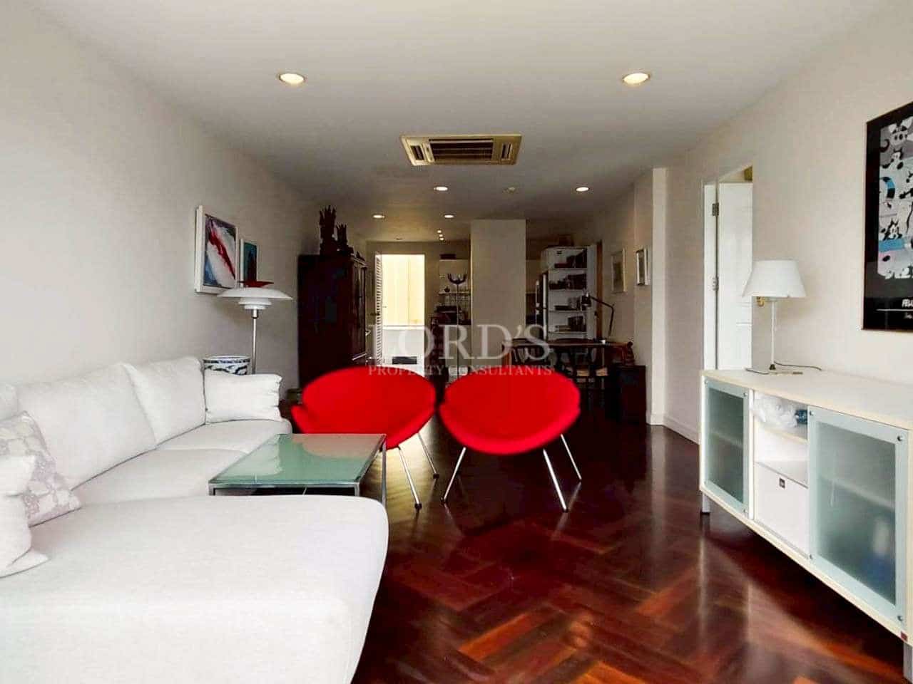 Modern living room with red chairs