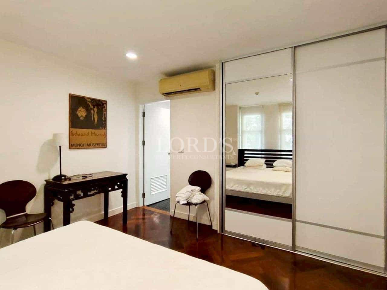 Modern bedroom with mirrored wardrobe