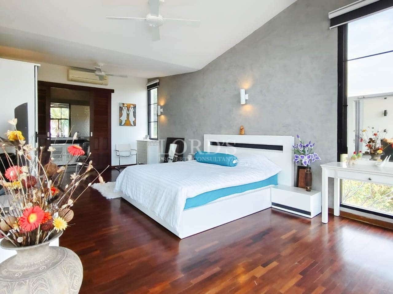 Modern bedroom with wooden flooring