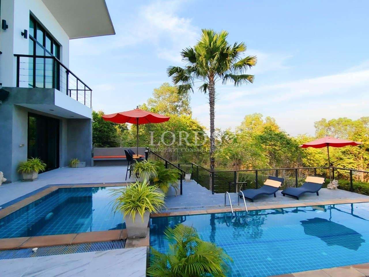 Modern villa with pool and greenery