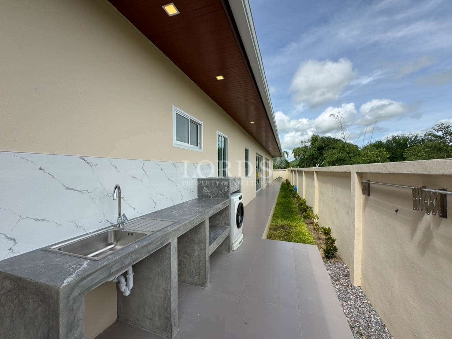Exterior laundry area with sink