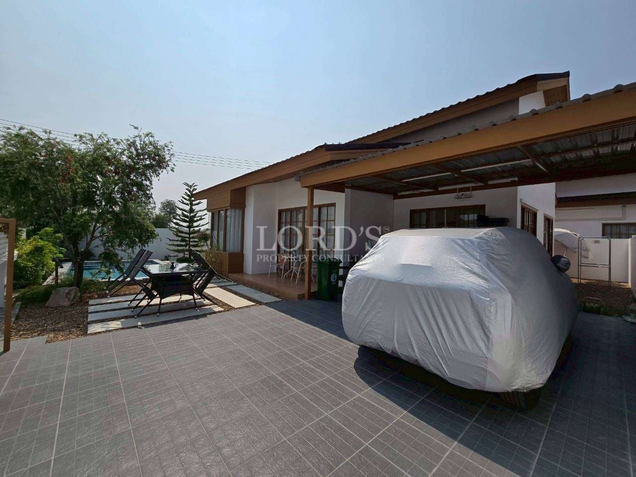 House with covered car outside