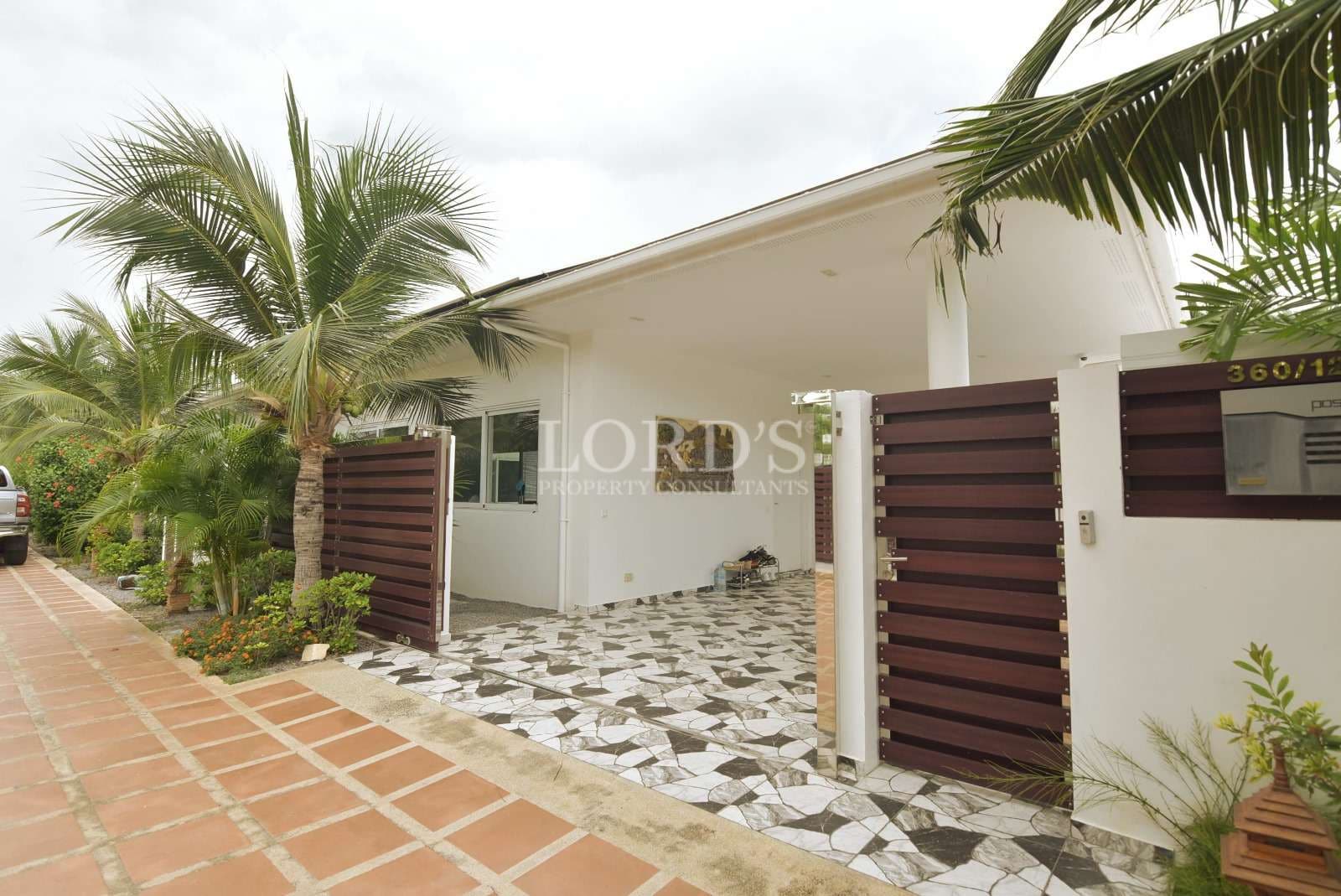 Modern house with tropical landscaping.