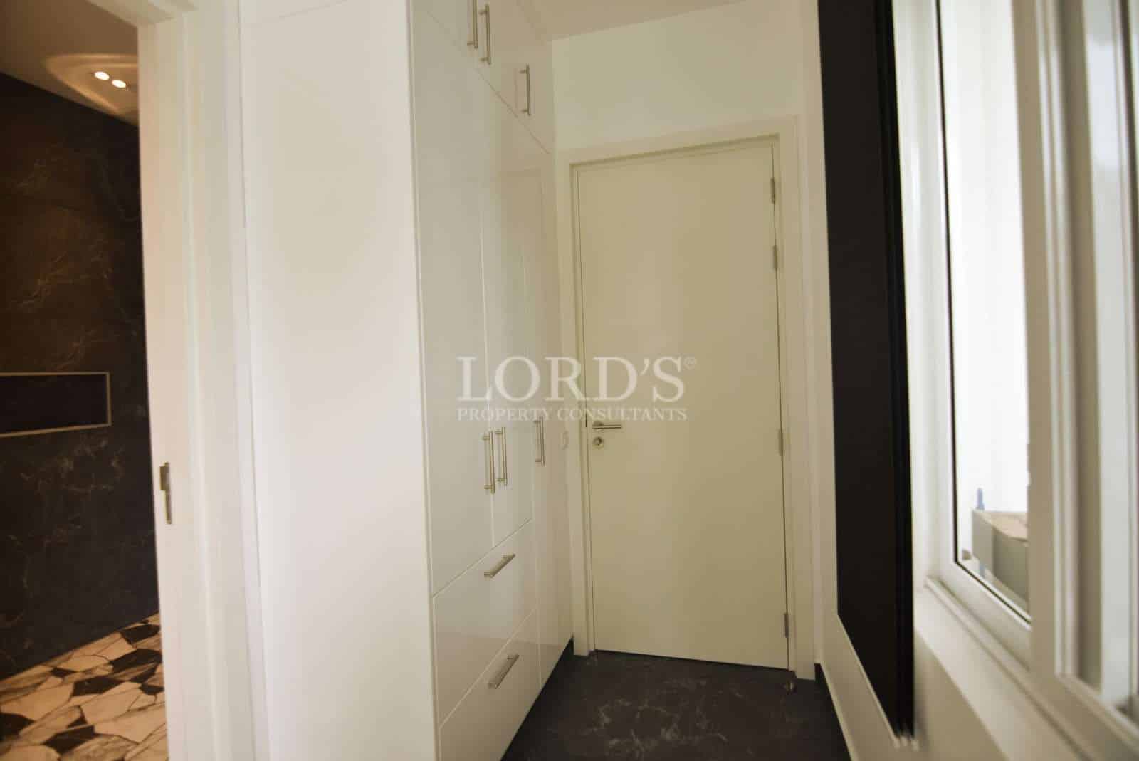 Modern hallway with white cabinetry.