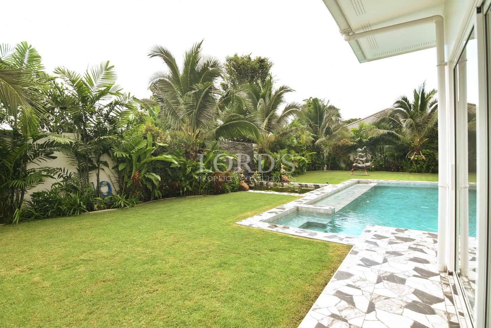 Lush garden with swimming pool.