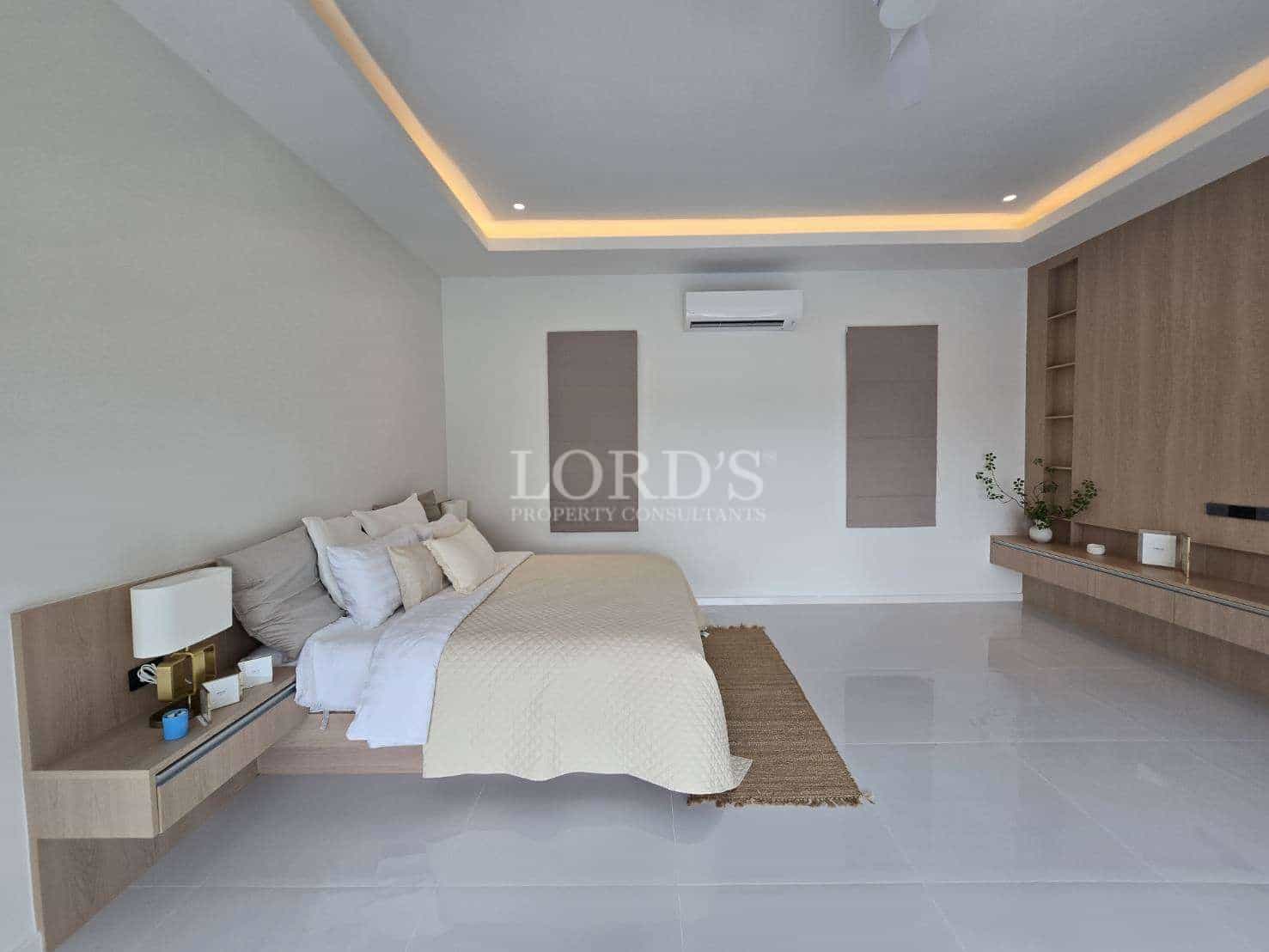 Modern, minimalist bedroom with neutral tones.