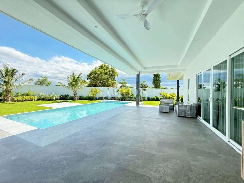 Modern patio with pool and greenery
