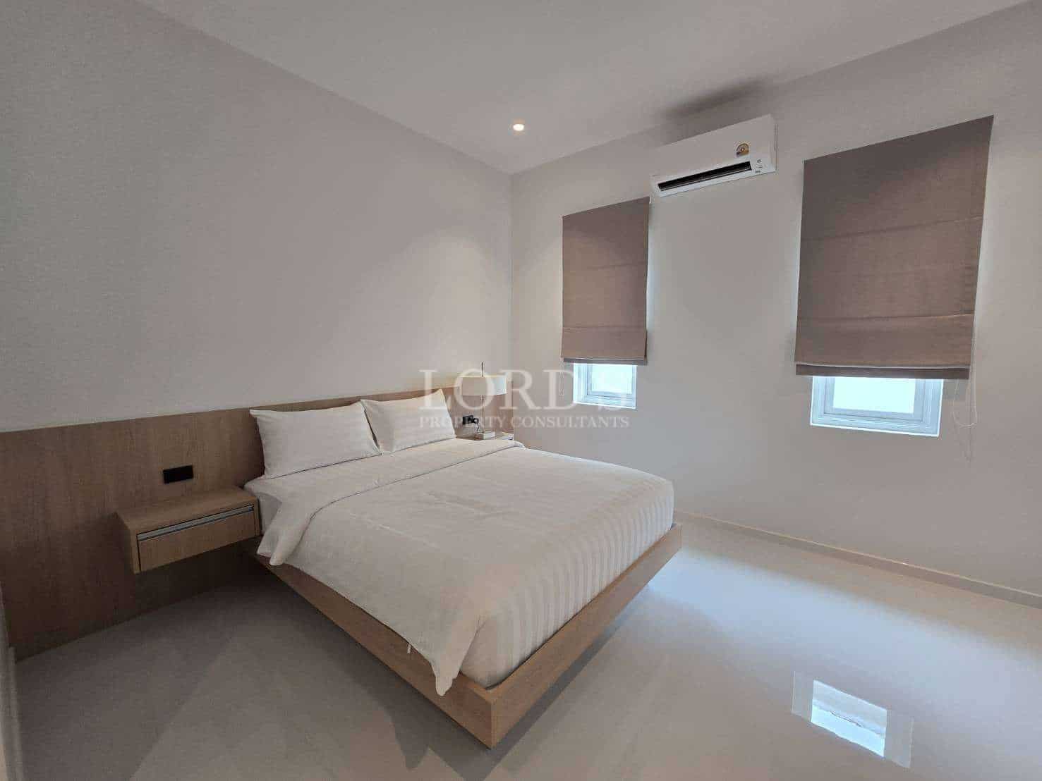 Minimalist bedroom with white bedding