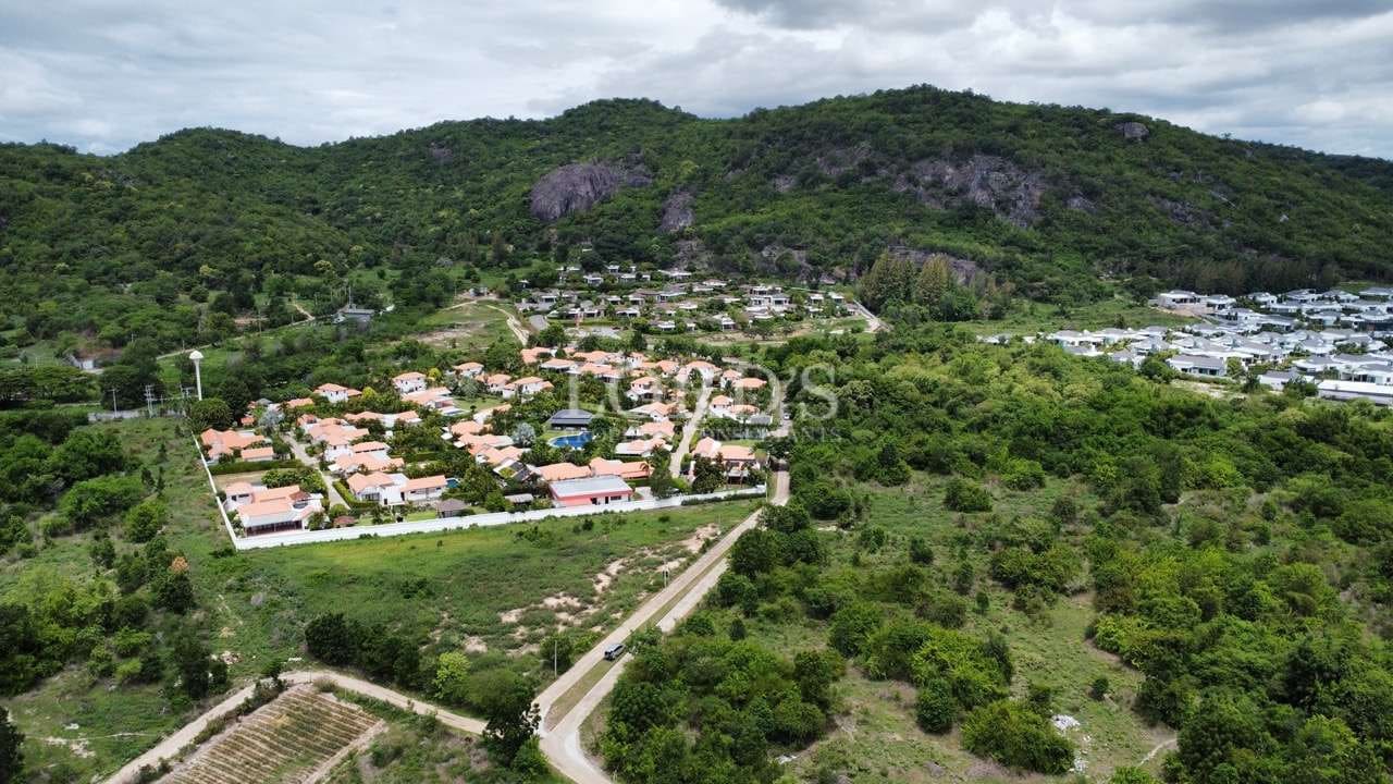 Aerial view of residential area and hills.