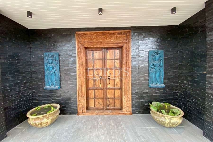 Elegant wooden door with sculptures