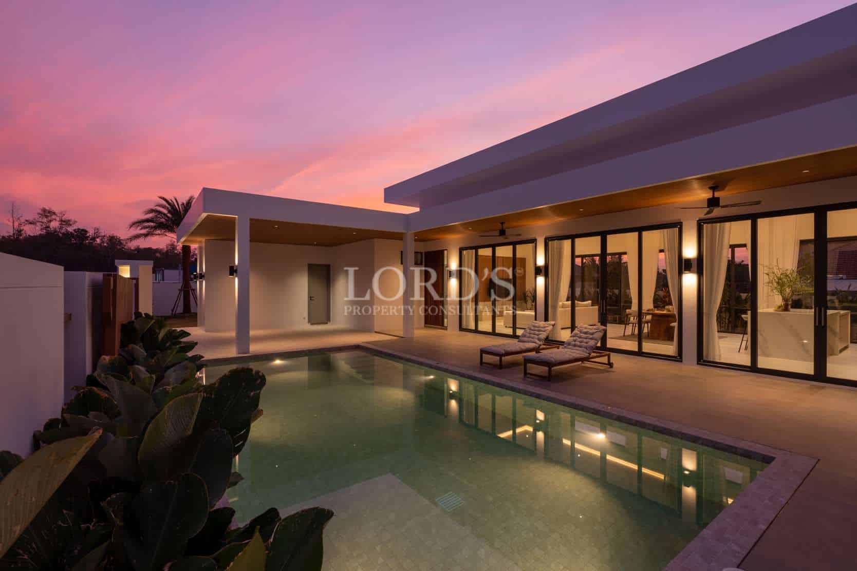 Modern villa with pool at sunset