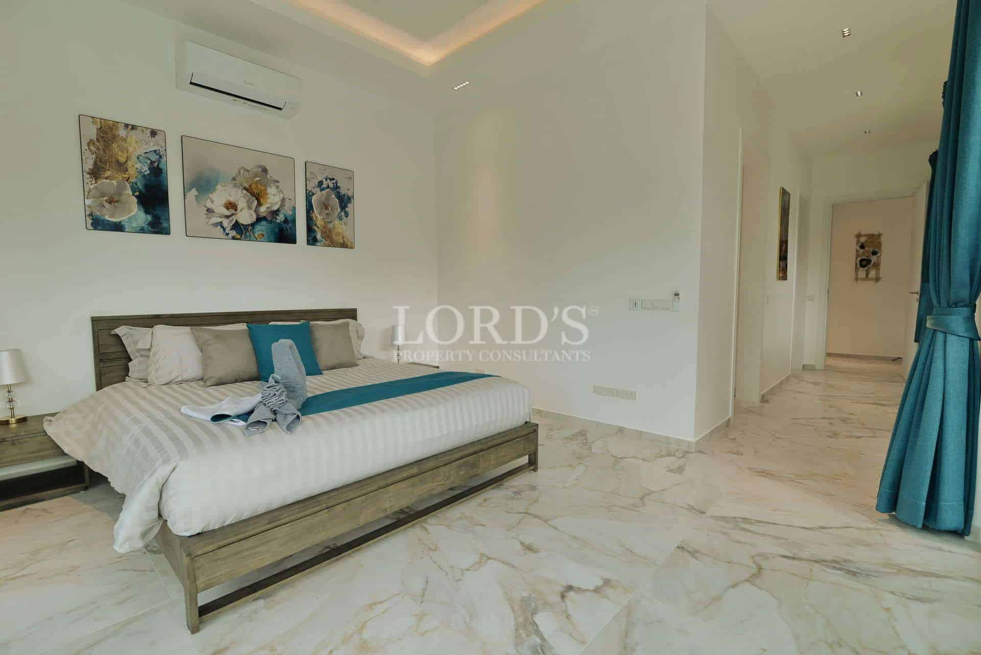 Modern luxury bedroom with marble flooring, king-size bed, soft accent lighting, and minimalist décor.