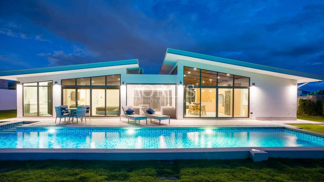 Modern house with pool at night