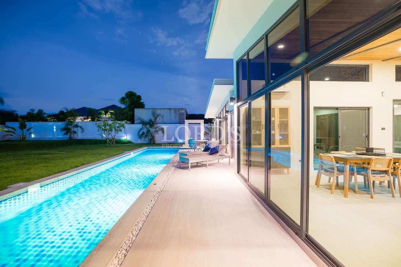 Modern home with pool at dusk