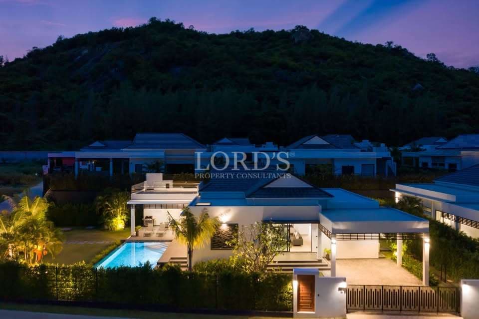 Modern villa with pool at dusk