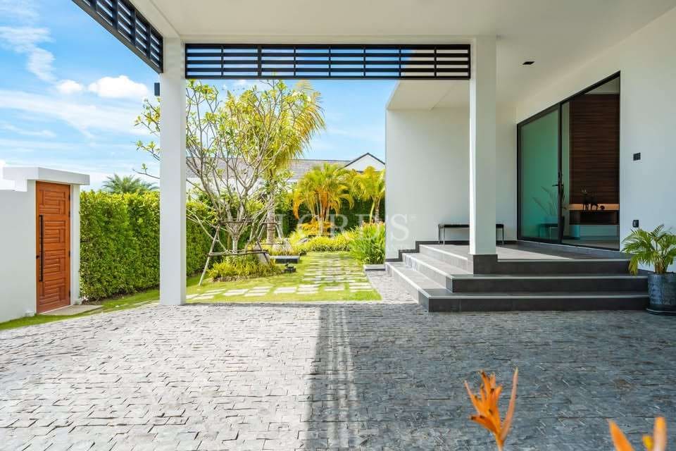 Modern entrance with lush greenery.