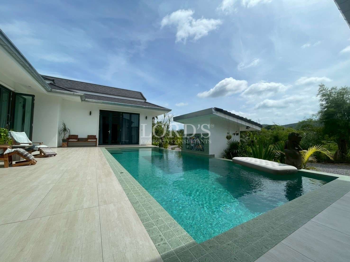 Modern villa with pool and greenery