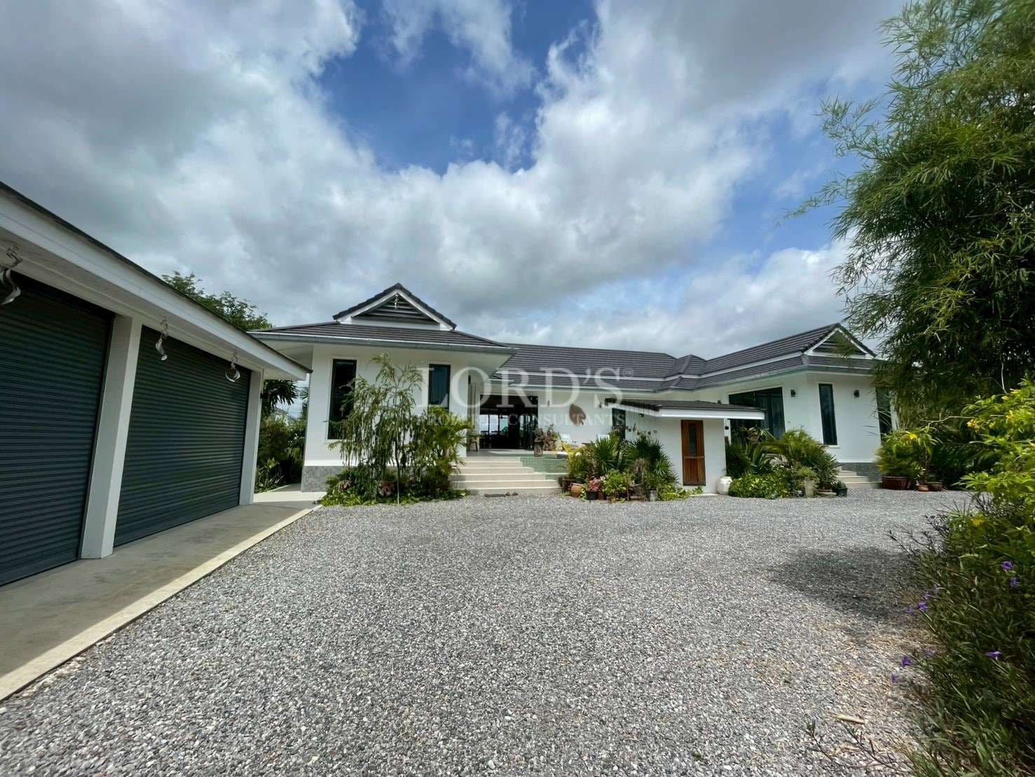 Modern house with landscaped driveway.