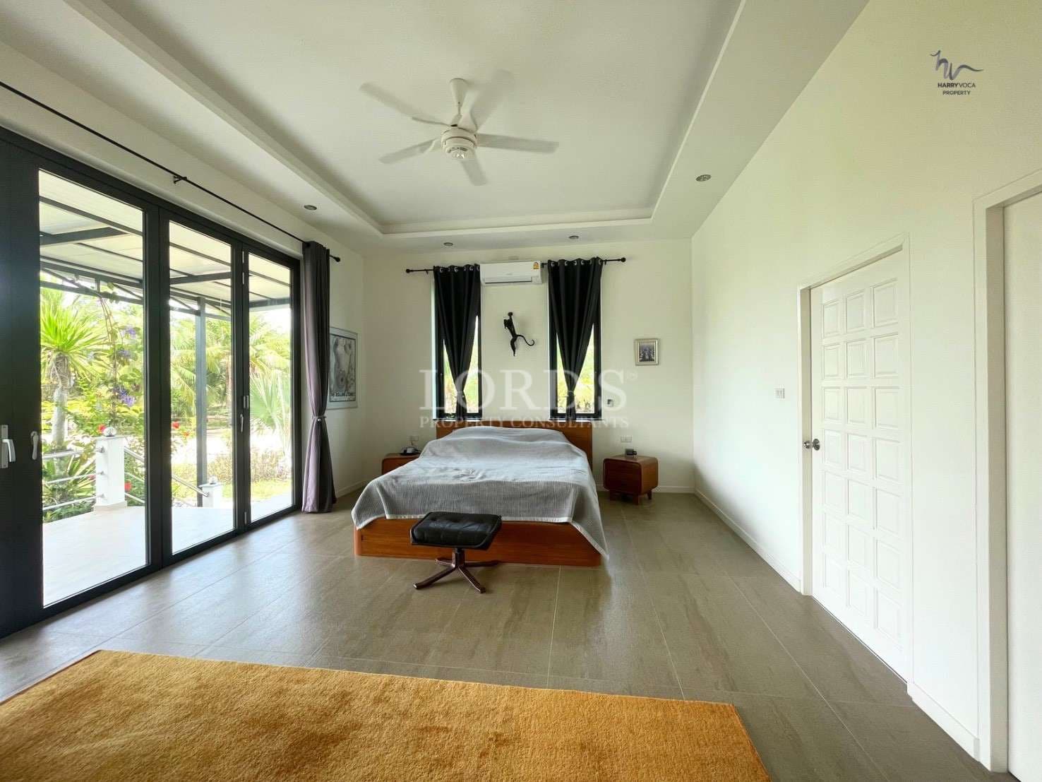 Spacious, modern bedroom with natural light.