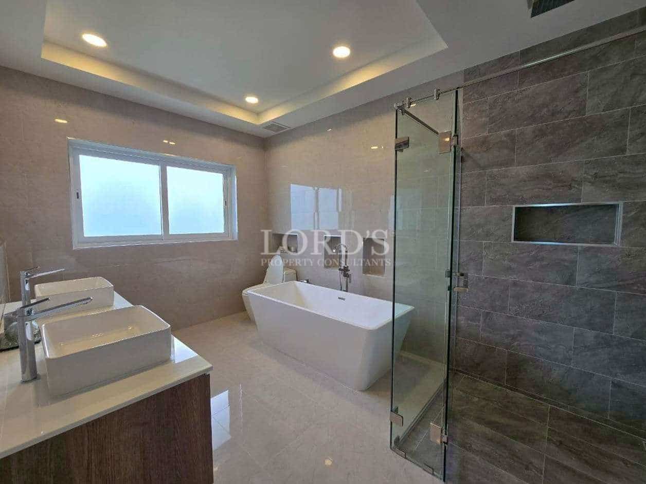 Modern carport with paved driveway.