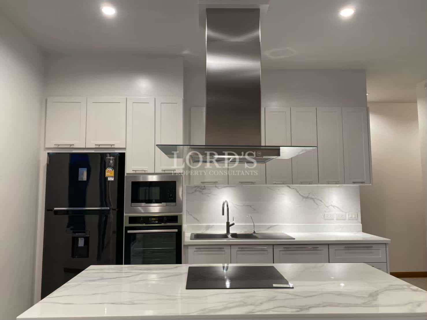 Modern kitchen with marble countertops.