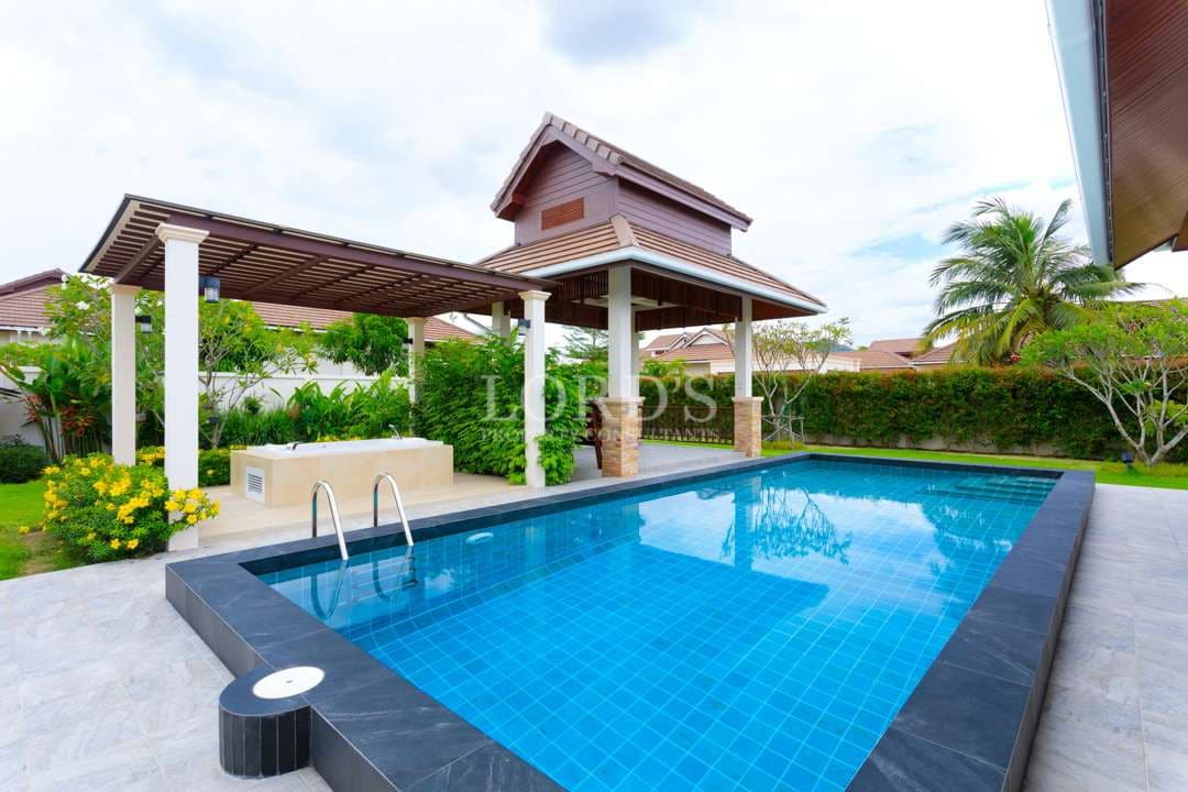 Luxury villa with private swimming pool, covered pavilion, and landscaped tropical garden