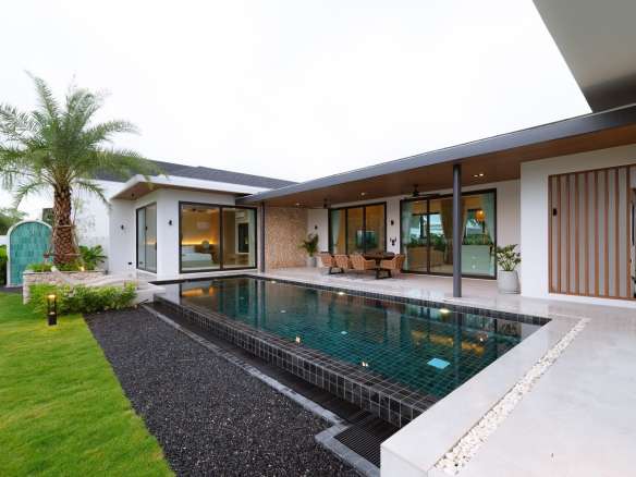 Modern single-story villa with private swimming pool, covered patio, palm tree landscaping, and open indoor–outdoor living.