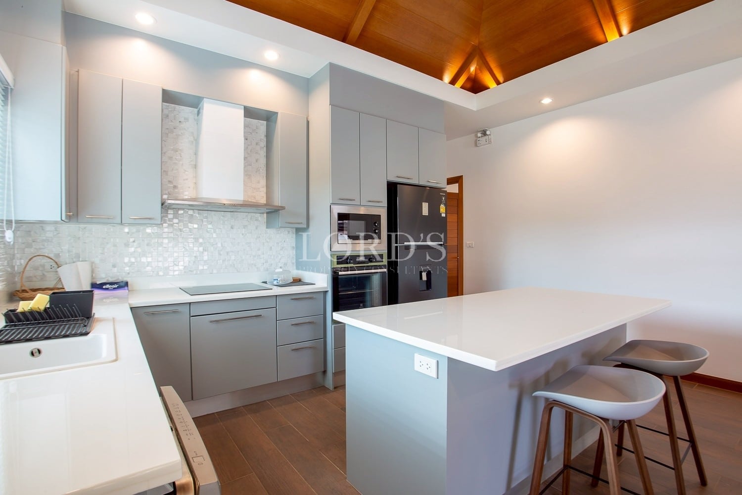 Modern kitchen with island counter, built-in appliances, and minimalist design