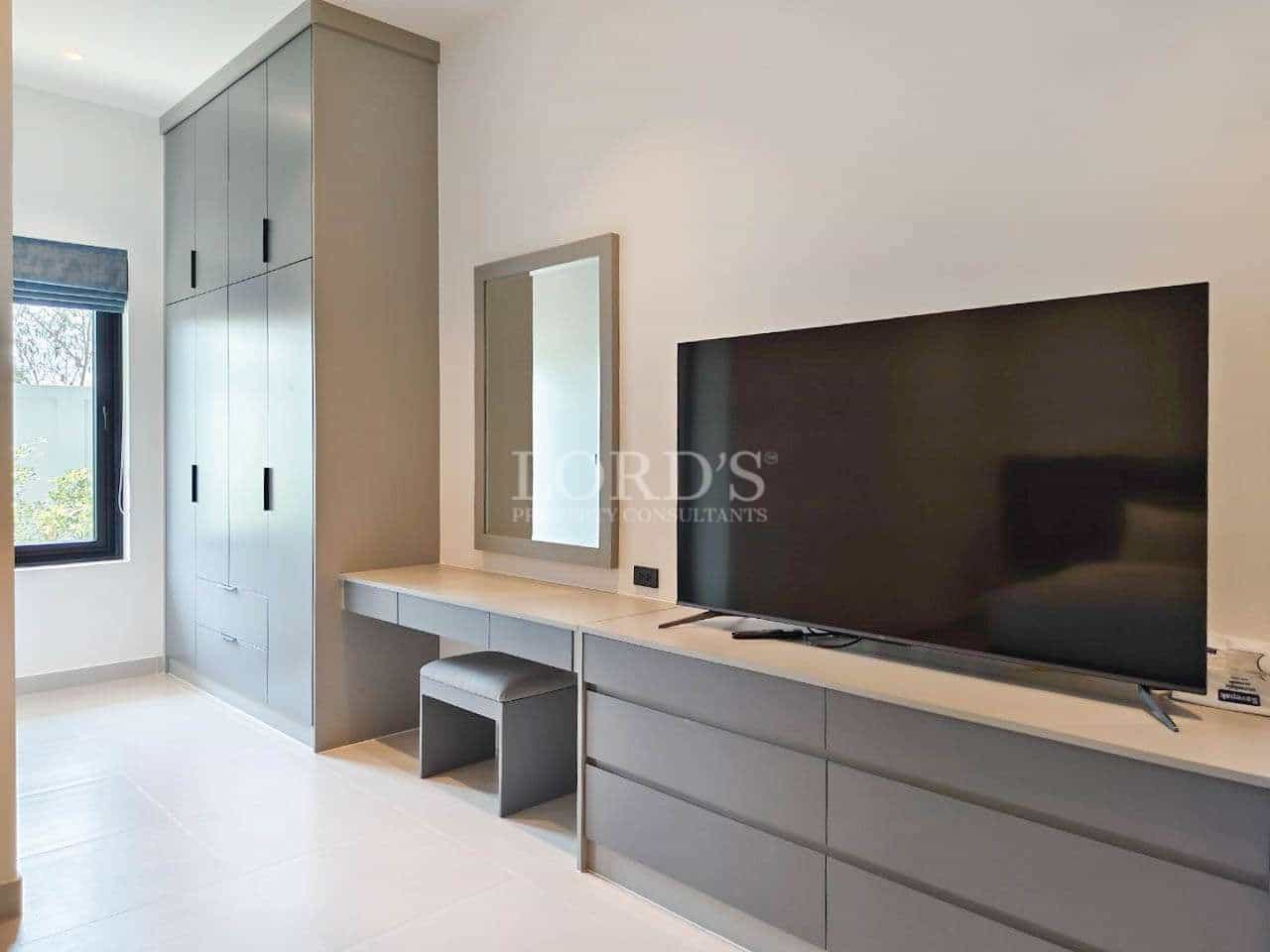 Modern bedroom with TV and storage