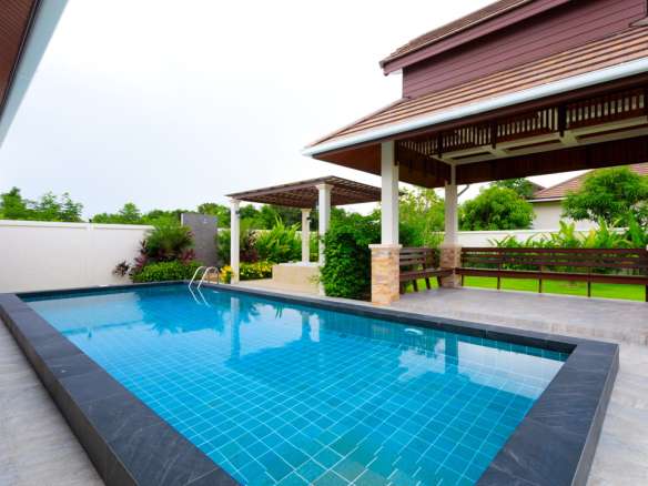 Modern poolside with covered seating