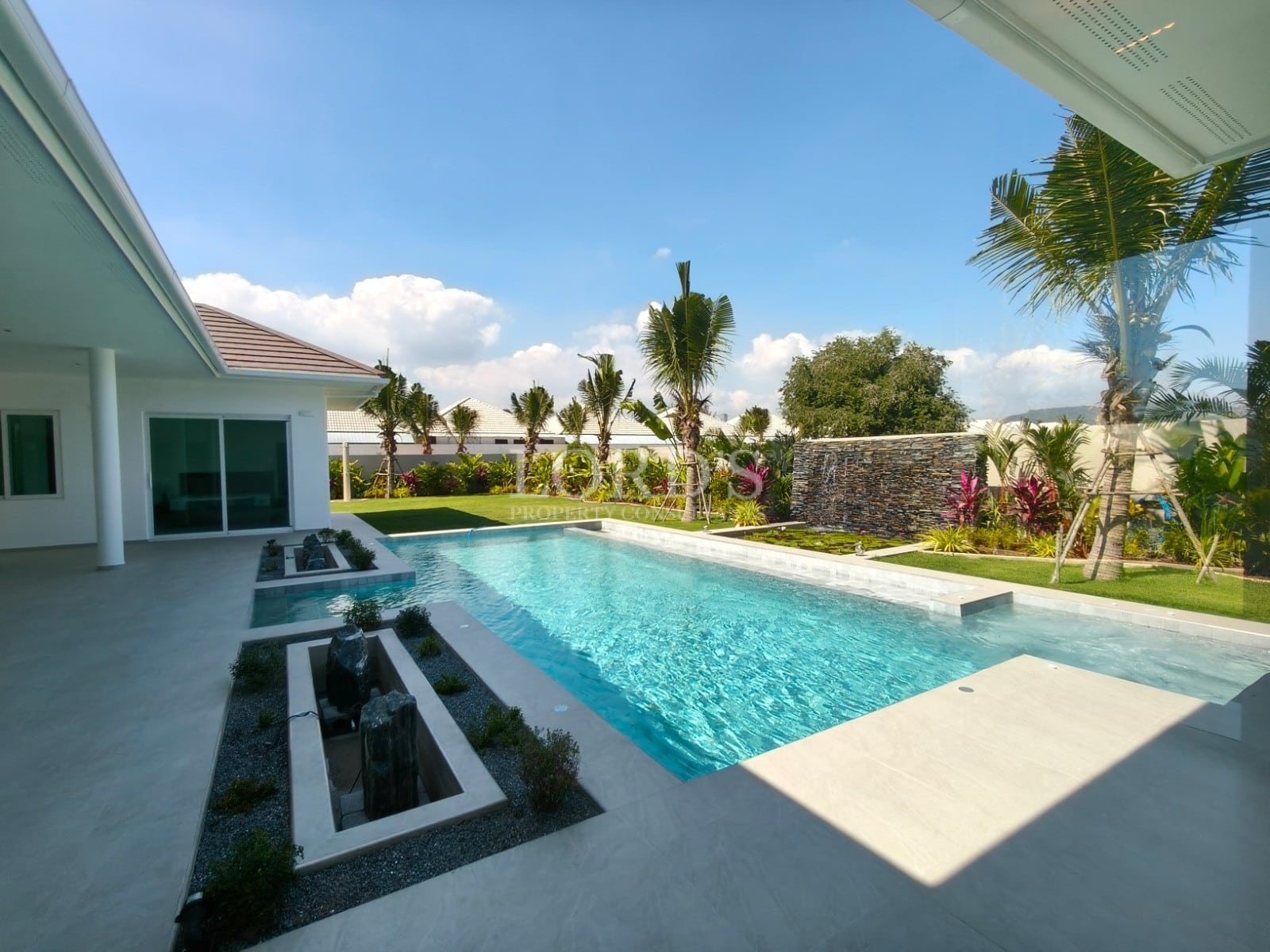 Modern poolside view with landscaping.