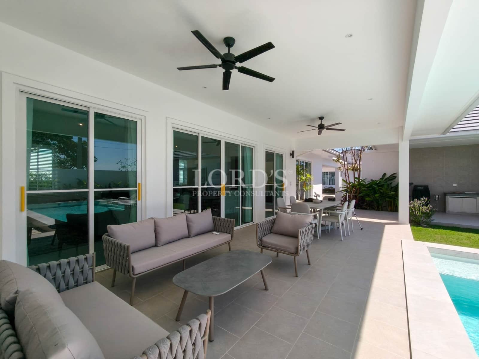 Modern patio with poolside seating.