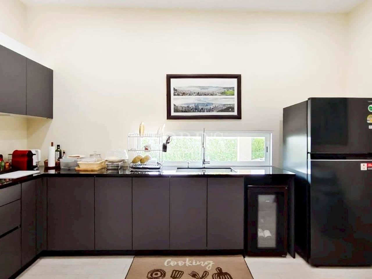 Modern minimalist kitchen with matte black cabinets, black countertop, and built-in appliances.