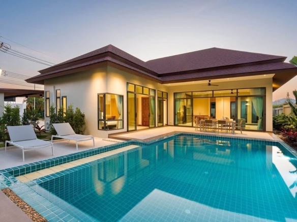 Modern single-story villa with private swimming pool and outdoor seating area.