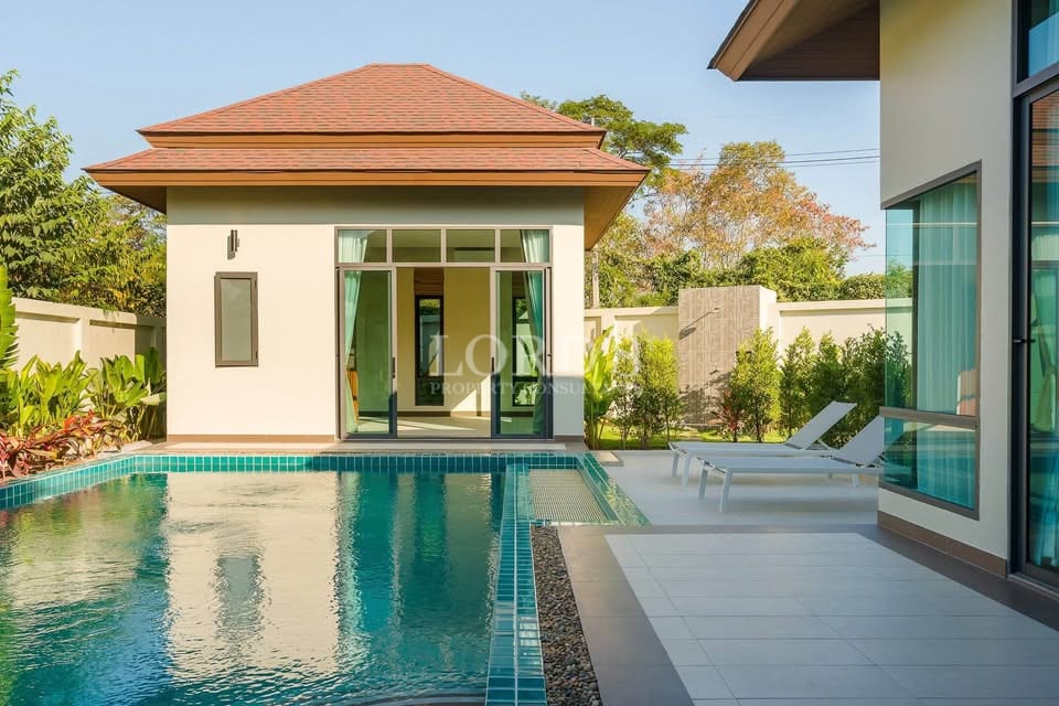 Modern villa with private swimming pool, sun loungers, and garden courtyard.