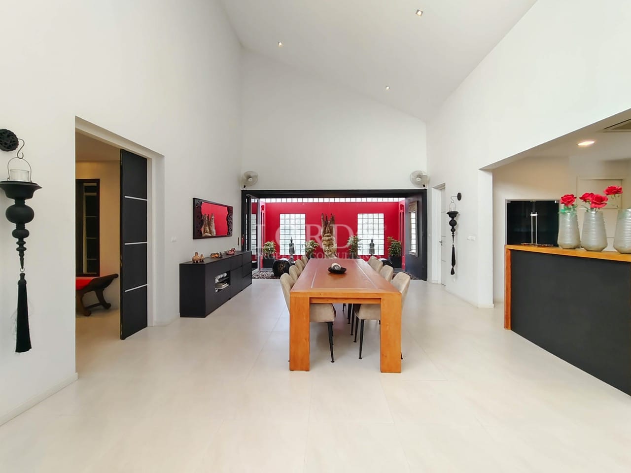 Spacious open-plan dining area with high ceilings and Zen courtyard view.