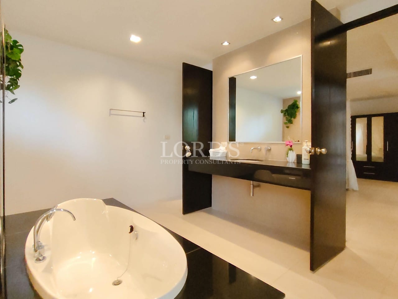 Modern luxury villa bathroom with freestanding bathtub and sleek vanity design.