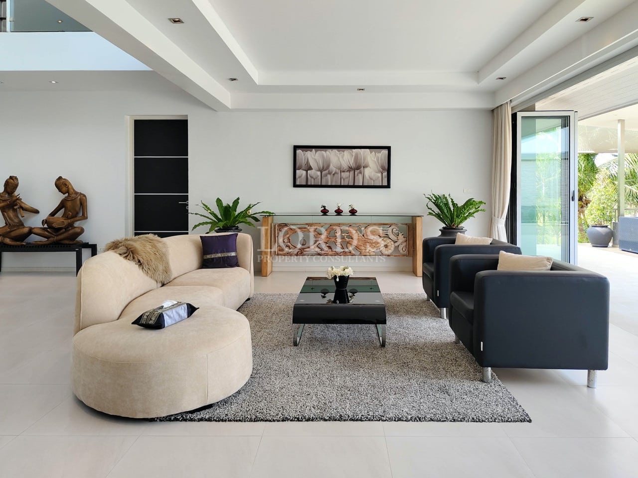 Modern luxury villa living room with elegant seating and natural light.